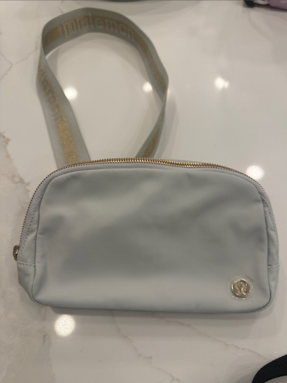 lululemon athletica light blue crossbody bag with gold logo